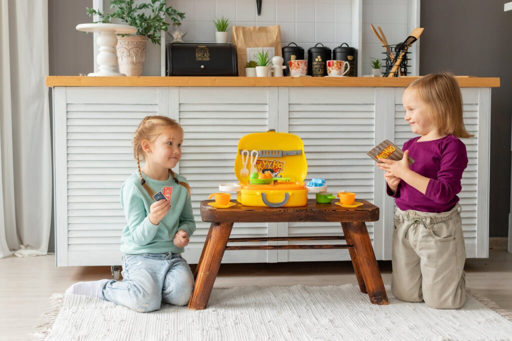 Two children playing with a wooden toy table