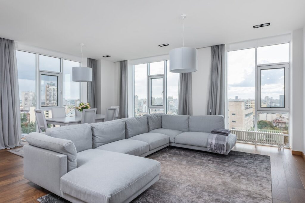 Spacious living room with comfortable sofa and panoramic windows